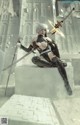 A woman sitting on top of a building holding two swords.