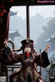 A woman dressed in a traditional chinese costume poses for a picture.