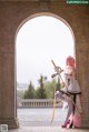 A woman in a white dress holding a sword.