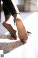 A close up of a person's feet on a table.