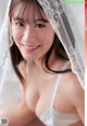 A woman in a white bra and a white veil.