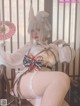 A woman sitting on a chair holding a fan.