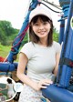 A young woman standing in front of a hot air balloon.