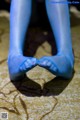 A pair of blue tights that are on the ground.